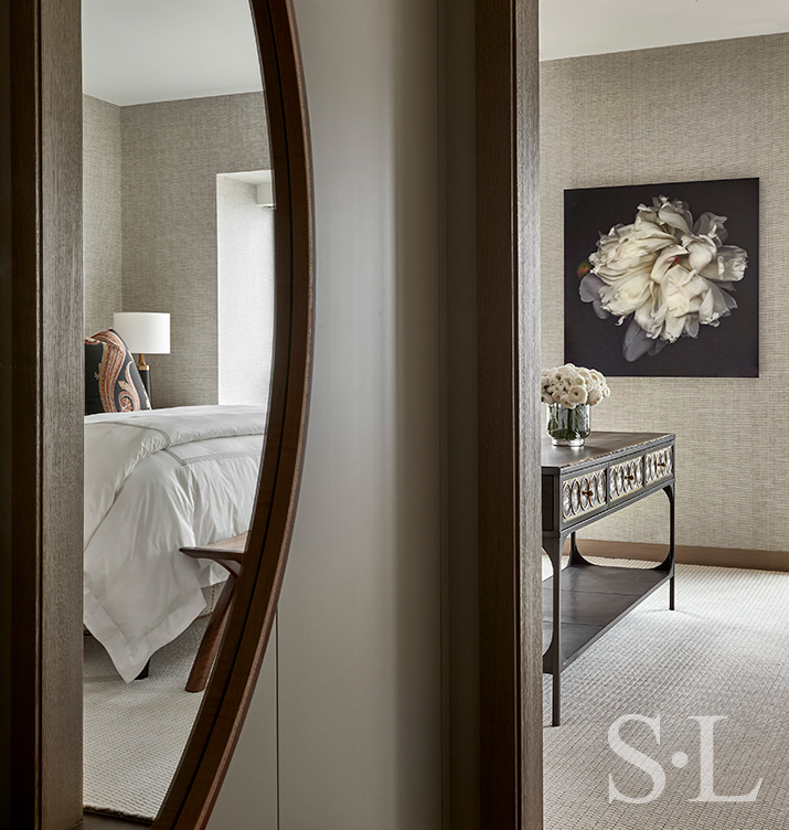 Chicago luxury apartment hallway detail with large mirror and view of floral artwork by John Grant