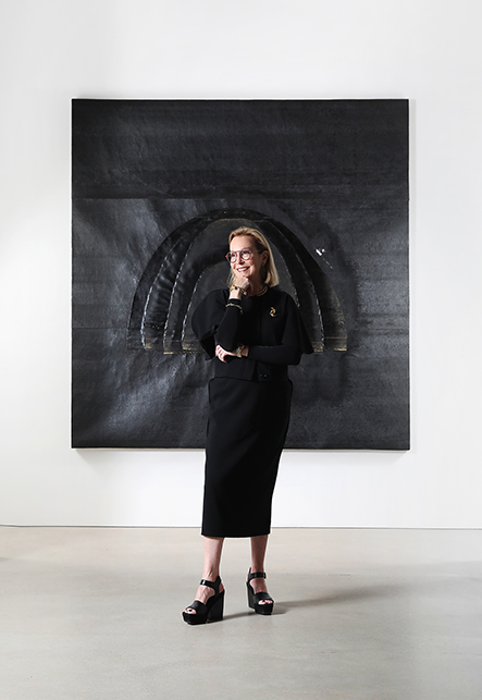 Interior designer Suzanne Lovell at Richard Gray Gallery Warehouse in front of artwork by Theaster Gates