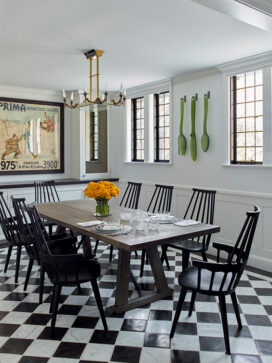 Scarsdale, NY kitchen renovation seating area with black and white checkered limestone and marble floor, a table with black Kartell Comback chairs
