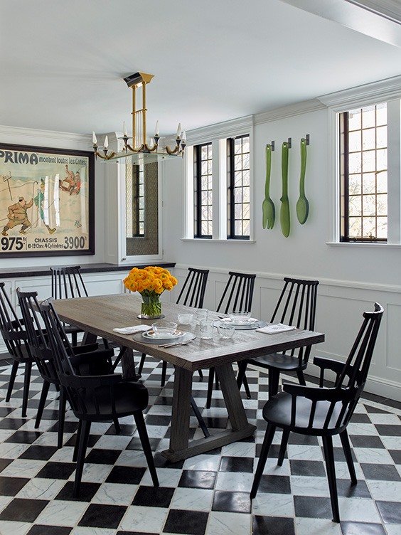Scarsdale, NY kitchen renovation seating area with black and white checkered limestone and marble floor, a table with black Kartell Comback chairs