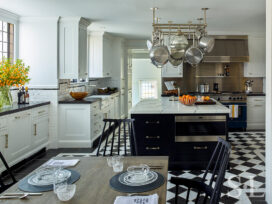 Scarsdale, NY kitchen renovation featuring black and white floor and large black center island with pot rack above