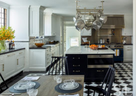 Scarsdale, NY kitchen renovation featuring black and white floor and large black center island with pot rack above