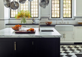 Scarsdale, NY kitchen renovation with original leaded windows, black and white floor and large black center island with pot rack above