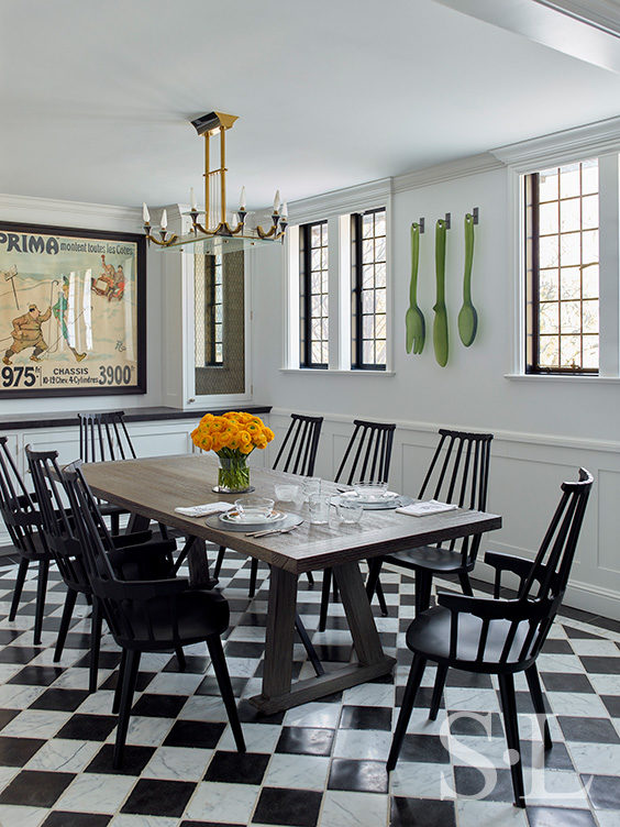 Scarsdale, NY kitchen renovation seating area with black and white checkered limestone and marble floor, a table with black Kartell Comback chairs