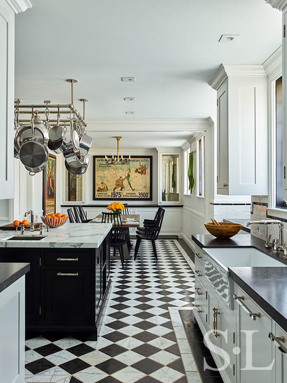 Scarsdale, NY kitchen renovation long-view with black and white checkered limestone and marble floor, a large black center island with pot rack above and kitchen table