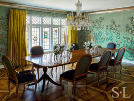 Scarsdale, NY dining room renovation with original leaded windows, large chandelier over table and floral wallpaper