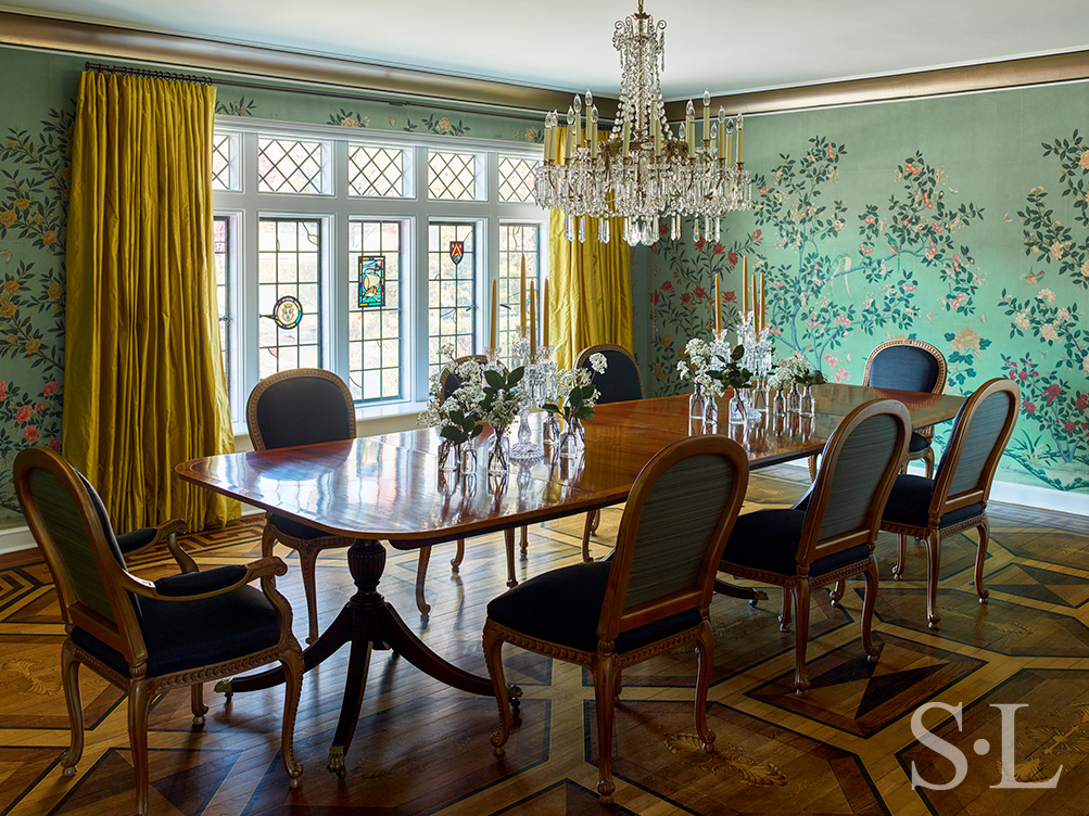 Scarsdale, NY dining room renovation with original leaded windows, large chandelier over table and floral wallpaper