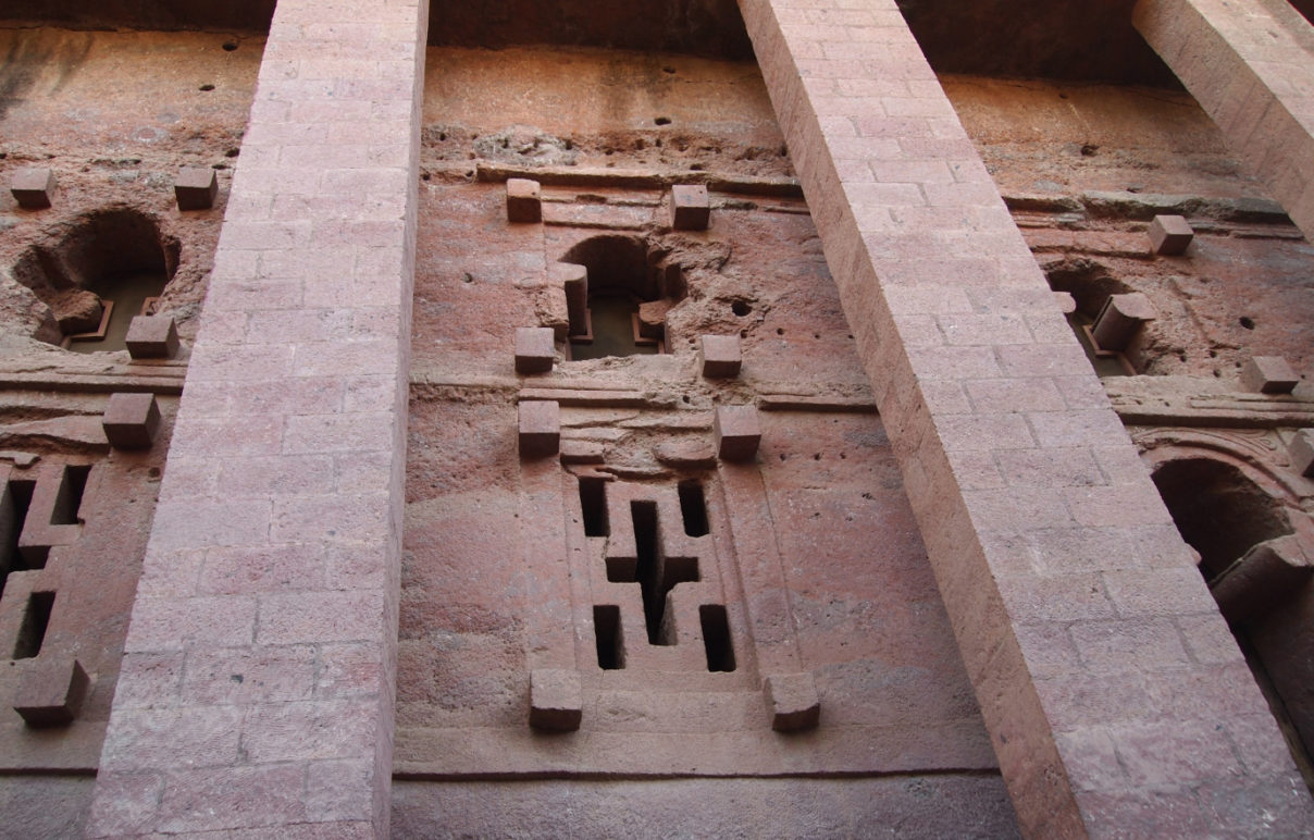 Priest in Bet Danaghel Church holding the Cross of King Lalibela. The  rock-hewn churches of Lalibela make it one of the greatest  Religio-Historical sites not only in Africa but in the Christian