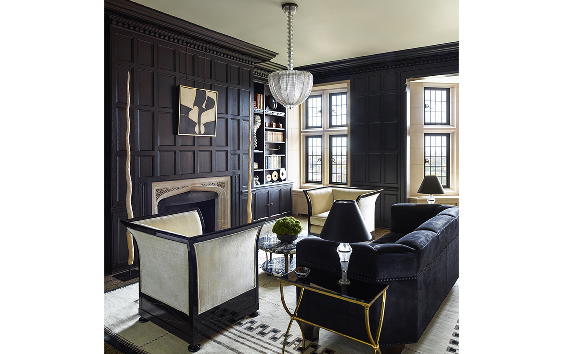 Library with dark wood paneling in Lakeview Residence designed by Suzanne Lovell