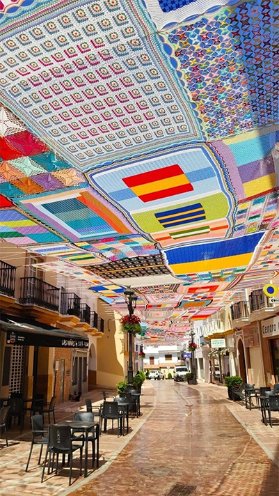 Massive Crochet Canopy Provides Color and Shade in Hot Spanish Town.