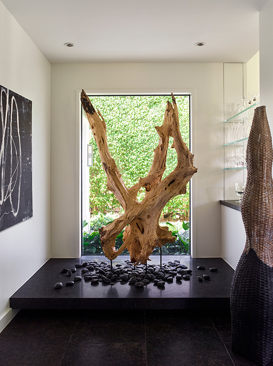 Foyer featuring a sculptural, oversized piece of driftwood