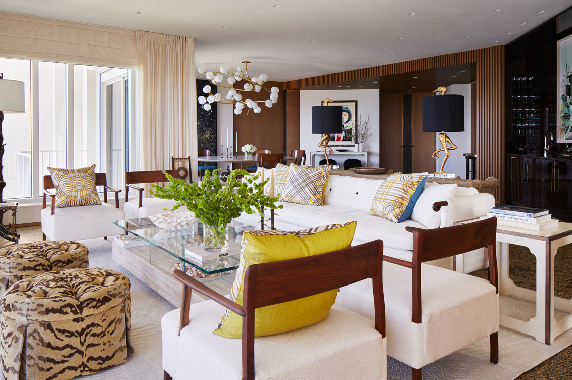 Light and bright great room interior designed with decorative pillows by Hermès and sofa by Robert Crowder