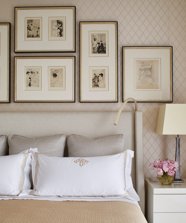 Master bedroom detail with gallery wall above headboard
