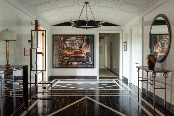 Large and welcoming entry gallery luxury interior renovation featuring artwork by Andrew Moore and Sidney Gordin