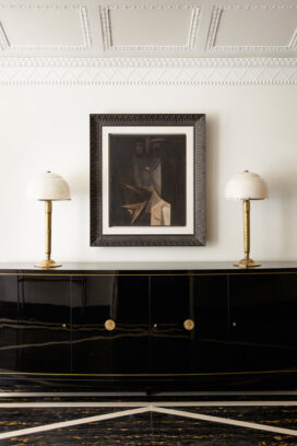 Entry gallery detail featuring artwork by Wilfredo Lam and a black lacquer De Coene Frères sideboard