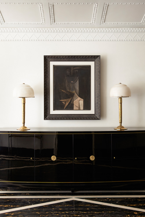 Entry gallery detail featuring artwork by Wilfredo Lam and a black lacquer De Coene Frères sideboard