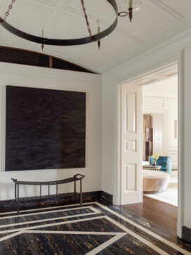 Entry gallery luxury interior renovation featuring artwork by Karen Gunderson and a bench by Ingrid Donat