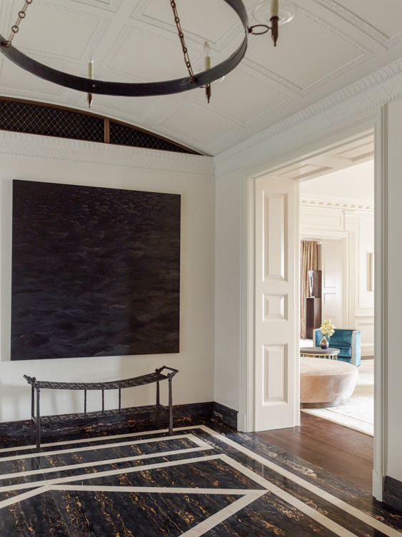 Entry gallery luxury interior renovation featuring artwork by Karen Gunderson and a bench by Ingrid Donat