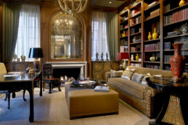 Library in Chicago Lincoln Park residence designed with walnut beams, fireplace and Tibetan chests
