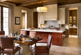 Kitchen with a Chinese-red lacquered island in Chicago residence designed by Suzanne Lovell Inc.