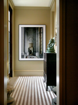 Hallway with striped rug and artwork by Robert Polidori