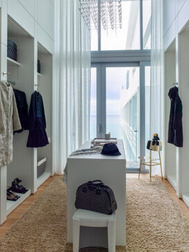 Custom designed master closet paneled with lacquered millwork