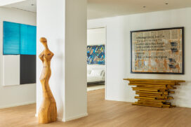 View outside of guest suite with artwork by Callum Innes and a console by Hervé van der Straeten