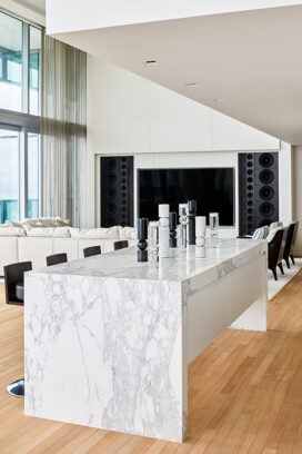 View towards living room showing central island and candlesticks by Lee Broom