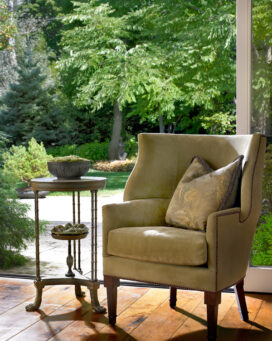 Dining room detail showing chair and table, view to exterior landscaping
