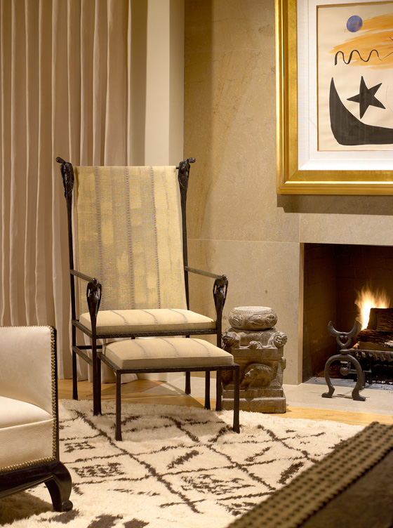 Living room fireplace detail showing chair by Ingrid Donat and Gene Summers andirons