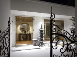 Exterior view of front door, showing French wrought iron entry gates and a Japanese copper pagoda