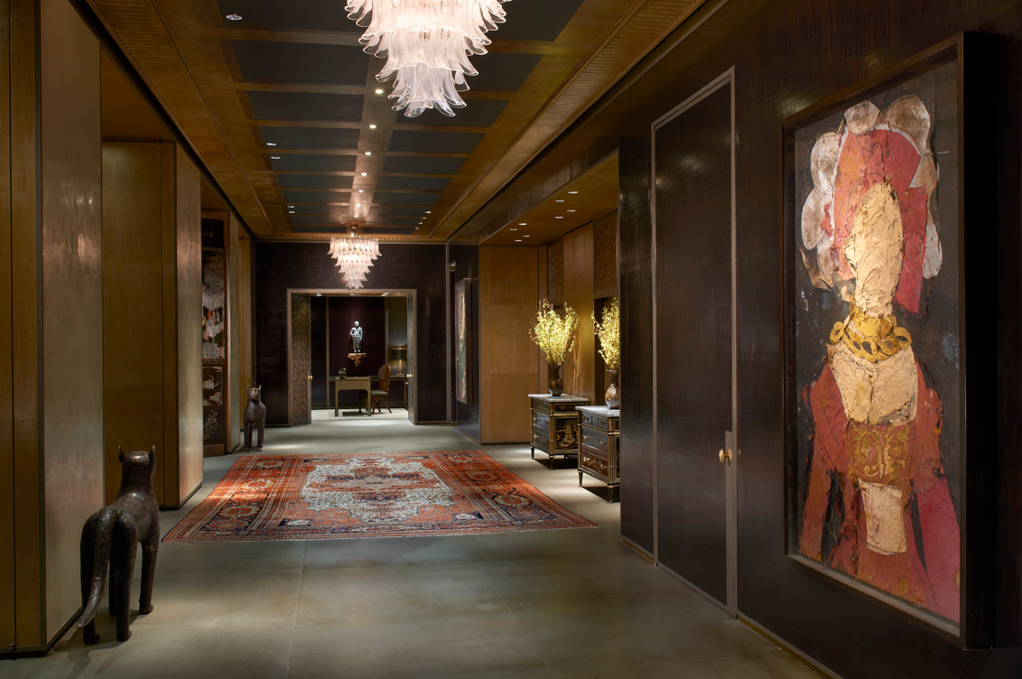 Entry gallery of Chicago skyline penthouse with walls in dark cashew lacquered plaster
