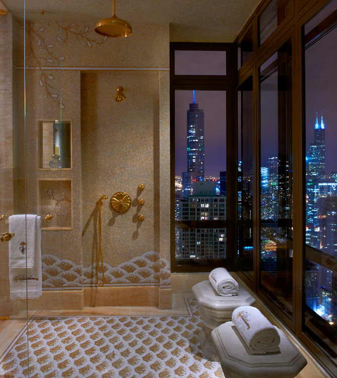 Penthouse wet room with honey onyx mosaic and view of Chicago skyline at night