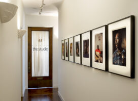 Deco-era duplex apartment hallway with photographs by Lee Friedlander