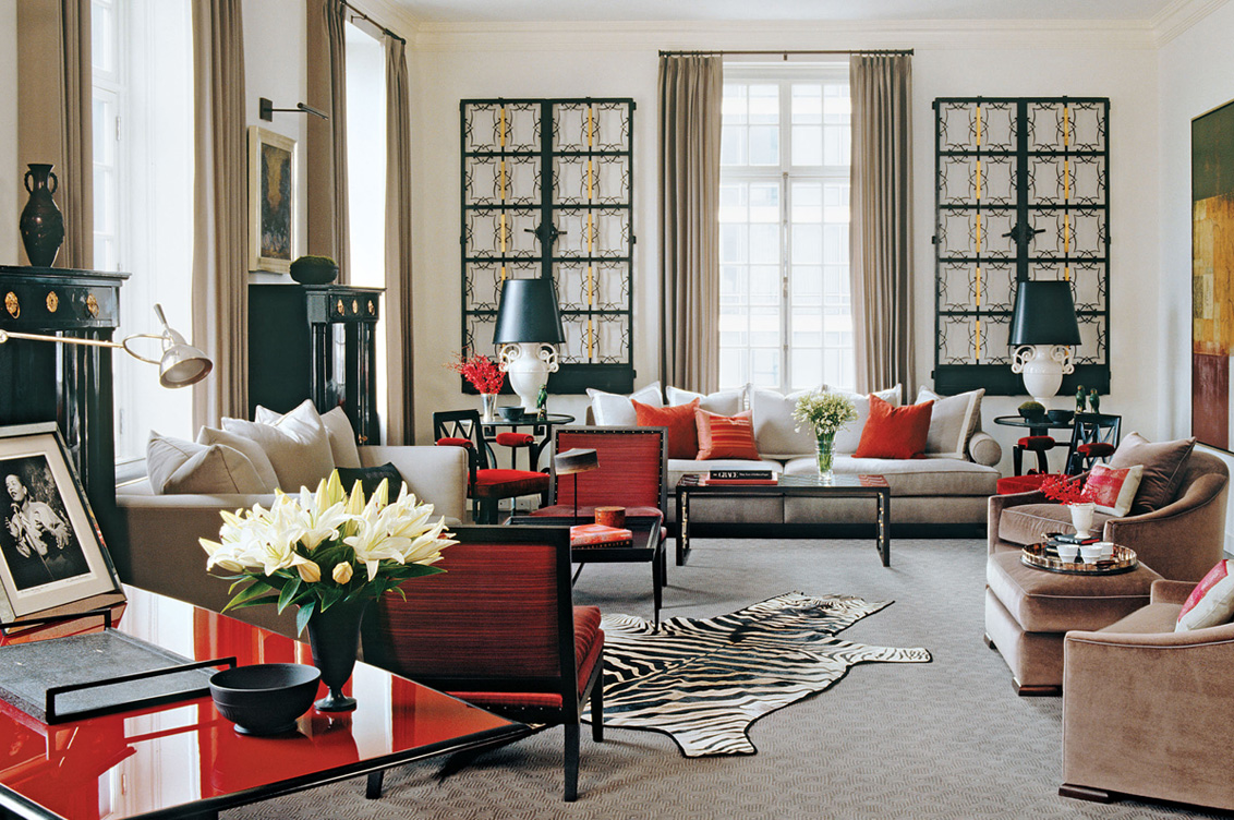 Deco-era duplex apartment living room in grey with red accents featuring a pair of wrought-iron French gates on the wall