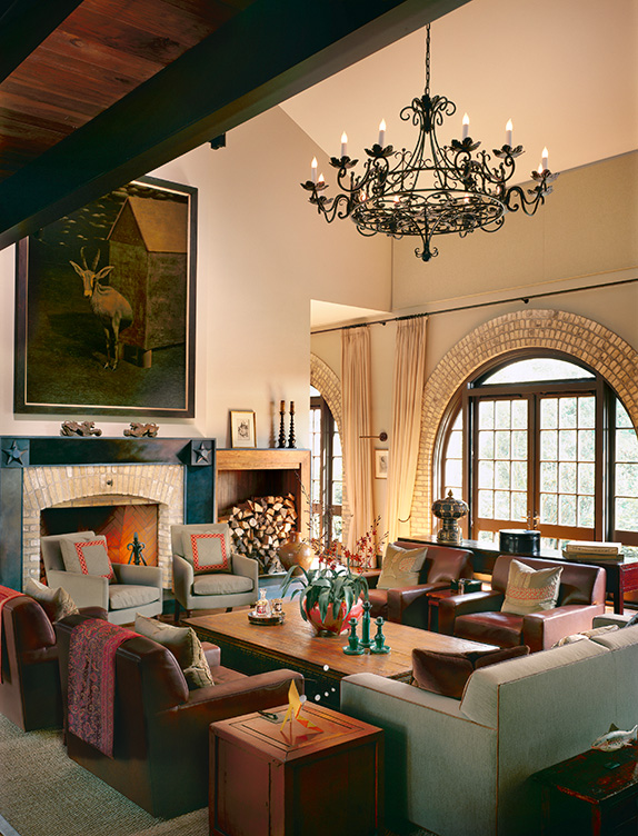 Living room of former artillery shed converted into luxury residence with 27-foot-high ceiling and arched windows