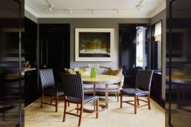 Fifth Avenue Pied-à-Terre dining room with artwork by Abelardo Morell and a round dining table with high gloss yellow lacquered wood top