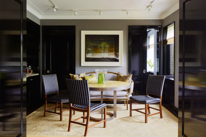 Fifth Avenue Pied-à-Terre dining room with artwork by Abelardo Morell and a round dining table with high gloss yellow lacquered wood top