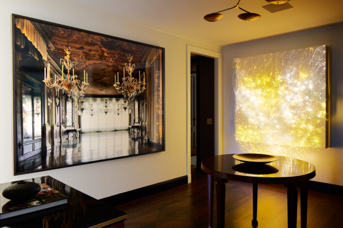 Fifth Avenue Pied-à-Terre foyer featuring photograph by Michael Eastman and a luminous wall sculpture by Astrid Krogh and brass chandelier by Lindsey Adelman