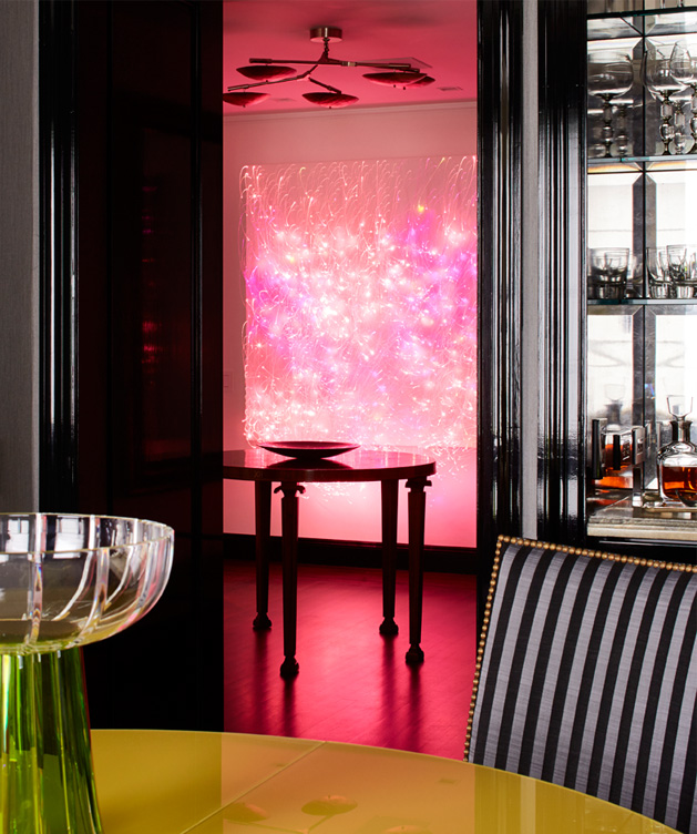 Fifth Avenue Pied-à-Terre view from dining table to foyer showing luminous wall sculpture by Astrid Krogh in hot pink