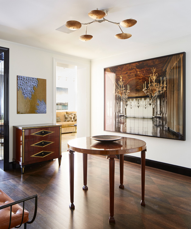 Fifth Avenue Pied-à-Terre foyer view towards dining room showing a photograph by Michael Eastman and Zodiac Table by Otto Schultz
