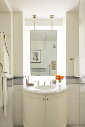 Fifth Avenue Pied-à-Terre bathroom in white and grey with a suspended vanity mirror and bow-front vanity