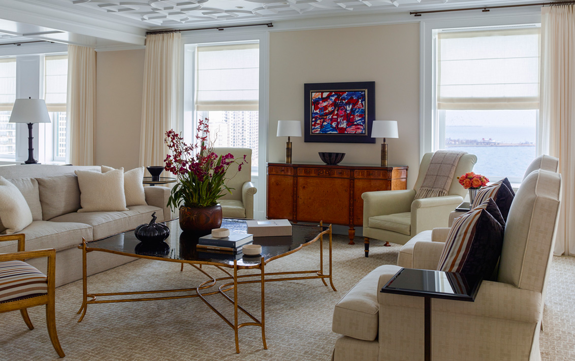 Chicago penthouse living room in a neutral palette with high-gloss plaster ceiling and artwork by Jean Dubuffet