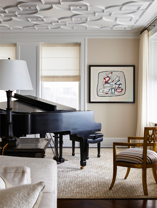 Detail of Chicago penthouse living room in a neutral palette with a piano and artwork by Jean Dubuffet
