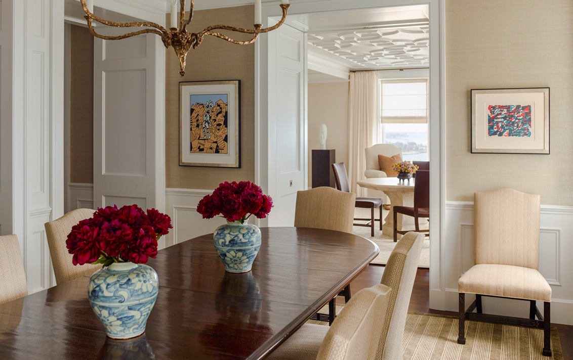 Chicago penthouse dining room and view into living room, featuring a mahogany table and Chippendale chairs