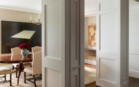 Chicago penthouse view into dining room through two large portals, with artwork by David Klamen