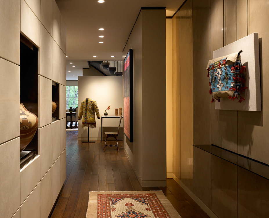 Lincoln Park Chicago landmark residence view from front door into foyer with display cabinet made of goatskin panels and collection of Native American objects and artifacts