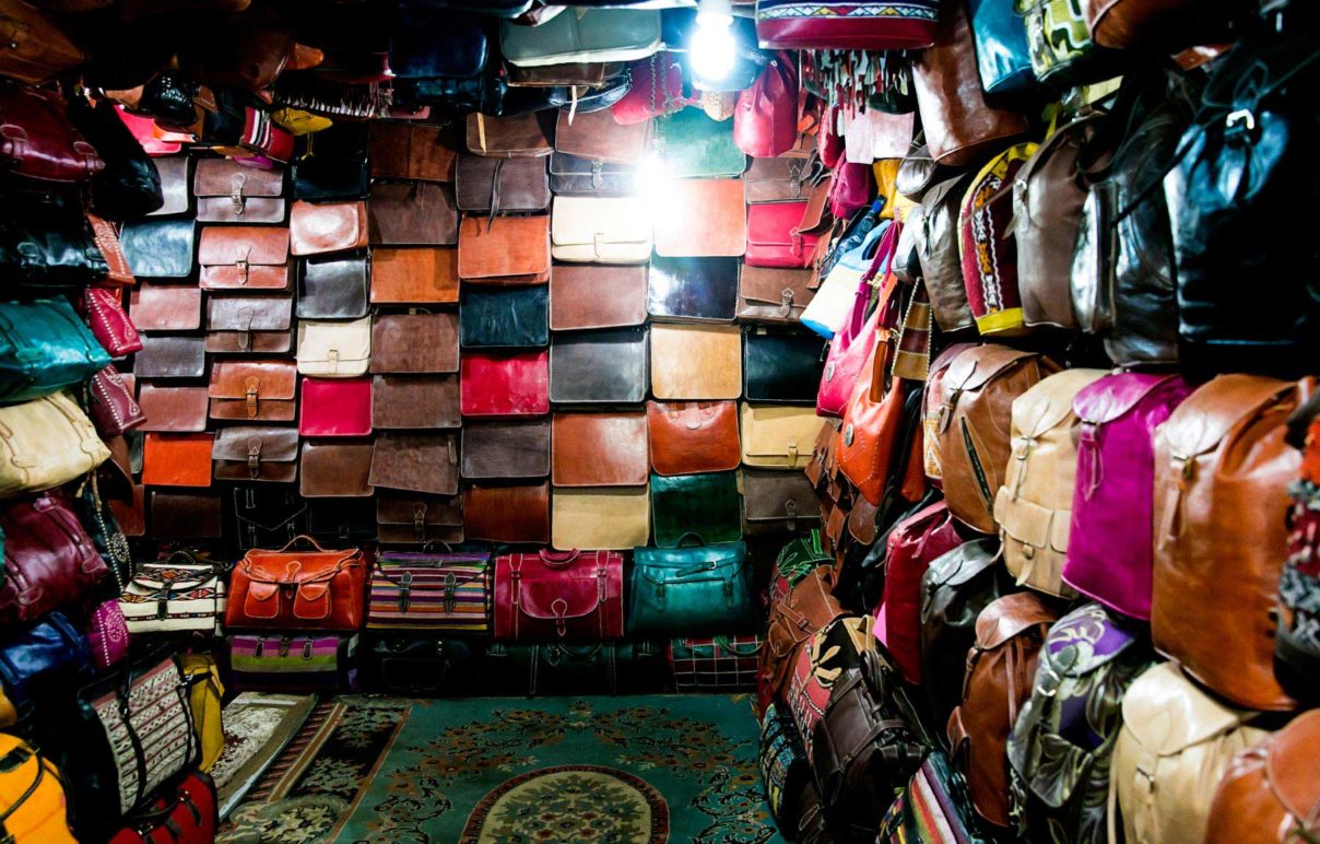 Leather handbags in a variety of colors in a shop