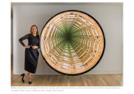 Portrait of Suzanne Lovell in the entry gallery of a penthouse in Miami which includes a large work by Iván Navarro