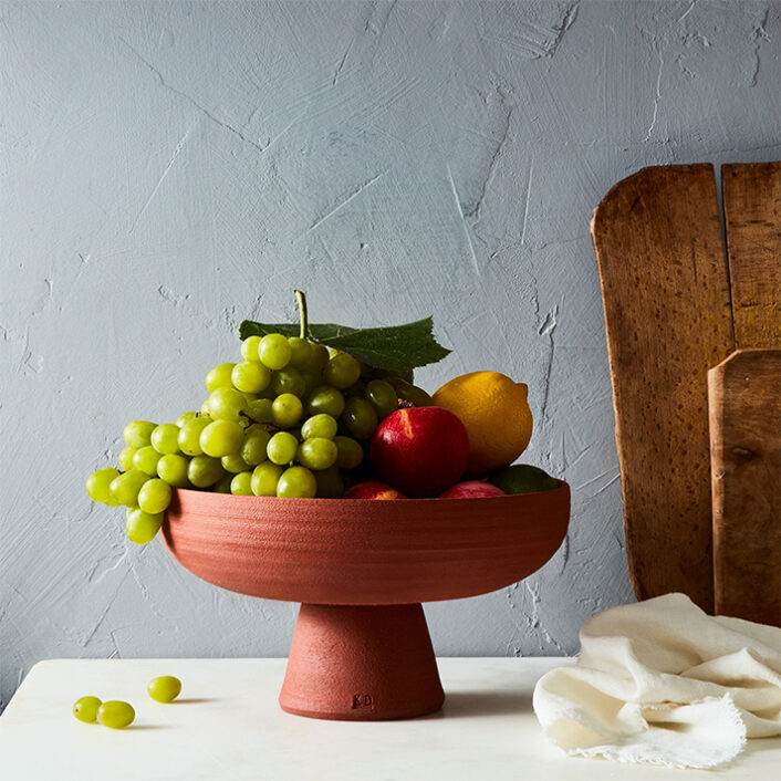 Earthen Clay Compote bowl, made from raw and unglazed Hawaiian red clay, with fruit inside